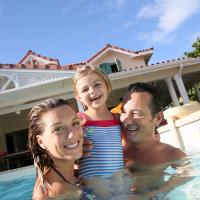 family playing in pool